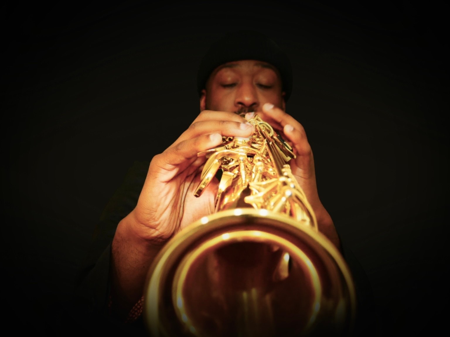 TAVE playing saxophone, photographed from the bell