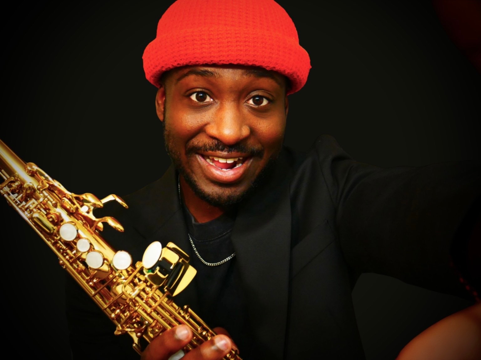 TAVE smiling with his saxophone